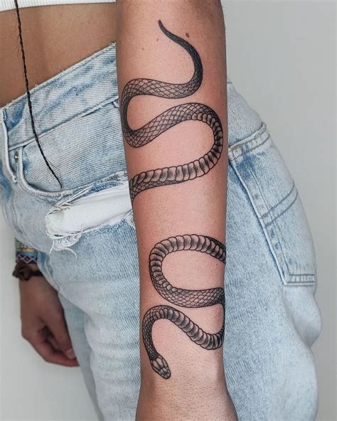 Snake wrapped around arm tattoo